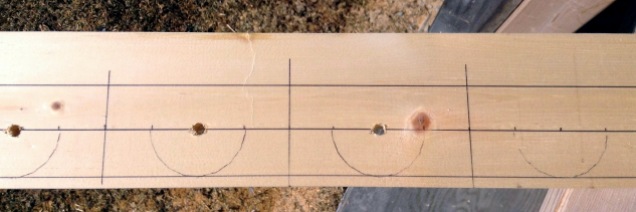 piece of wood with lines and circles to cut at
