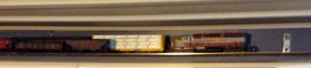 overlapping train cars on parallel lengths of model railroad track