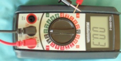 multi-meter device showing 00.3 on its display and its two probe ends touching each other