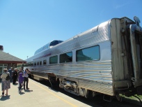 silver coloured rail passenger car with observation bubble on top